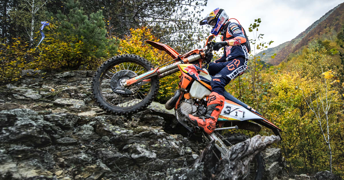 Hard enduro rider climbing a steep rock face