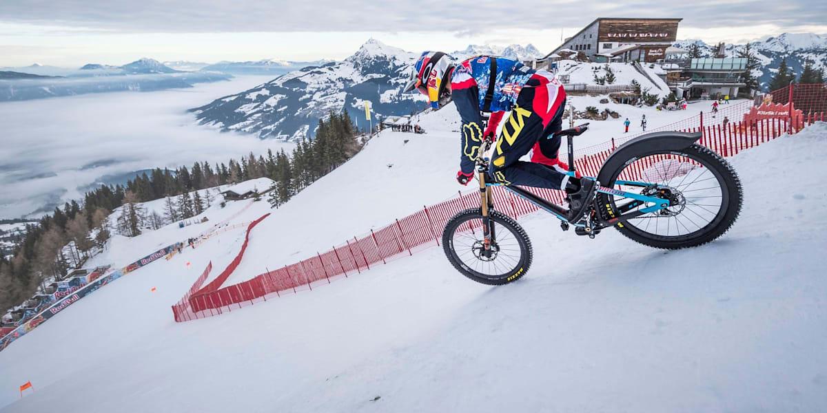 Max Stockl rides mountain bike down the Streif ski run