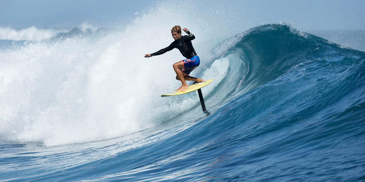 Surfboard with store underwater wing