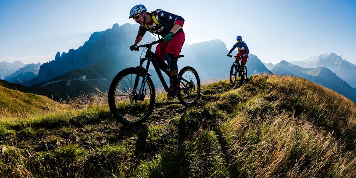 Mountain Biking In The Dolomites The Perfect MTB Guide   A Pair Of Mountain Bikers Riding In The Dolomites Range In North Eastern Italy