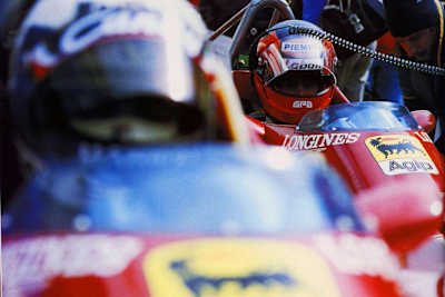 Gilles Villeneuve looks to his team-mate and competitor Didier Pironi at the starting grid of the 1982 F1 World Championship.