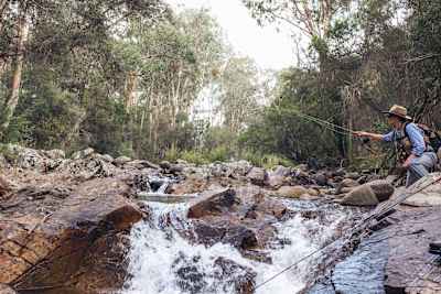 Casting fishing rod into a rocky stream in Australia.