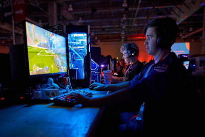 A QuakeCon 2018 attendee plays games on his PC in the BYOC area.