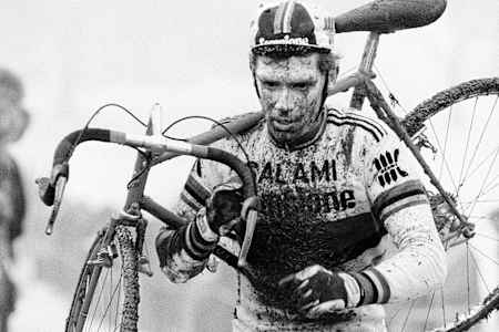 Swiss Cyclo-cross racer Albert Zweifel carries his cross bike during a race.