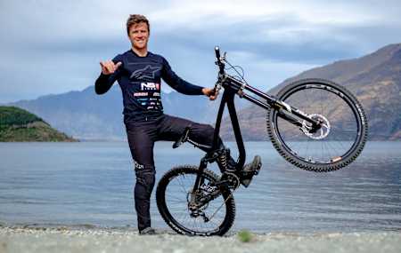 New Zealander George Brannigan as seen alongside his NS Bikes downhill bike in Queenstown, New Zealand.
