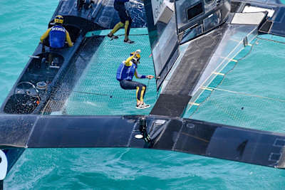 Nathan Outteridge is mid air as he runs to the other side of the boat during race 4 of Louis Vuitton America's Cup Challenger play-off semi-finals in Bermuda.