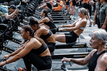 Competitors take on a rowing challenge during a HYROX fitness event