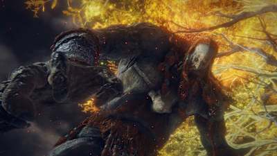 A giant stands against a backdrop of flames in Elden Ring.