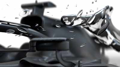 A photograph of the unpainted Scuderia AlphaTauri car with water droplets on the lens.