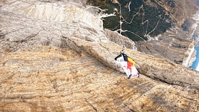  Fred Fugen wingsuit flying past a cliff face during production of Touching the Sky VR.  