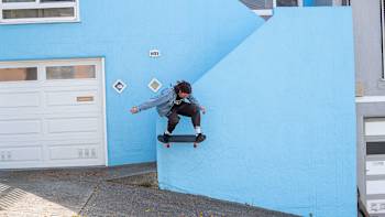 A skater does a trick in a street in San Francisco