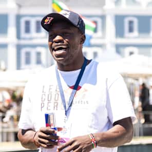 Patrick Odongo holding Red Bull can with a smile on his face. 