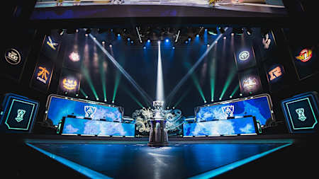 An image of the LoL Worlds stage and trophy