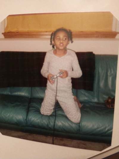 Pro Tekken player Cuddle Core playing PlayStation in her youth.