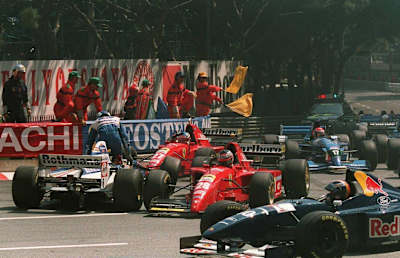 A photo of stewards stopping the 1995 Monaco Grand Prix and David Coulthard leaving his car after crashing with Jean Alesi and Gerhard Berger.