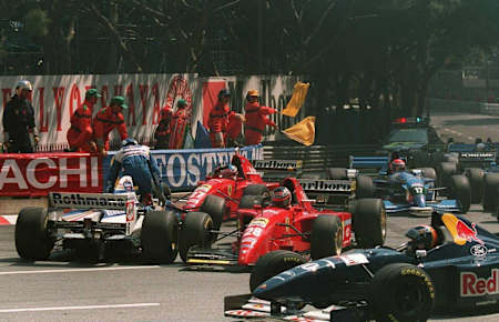 A photo of stewards stopping the 1995 Monaco Grand Prix and David Coulthard leaving his car after crashing with Jean Alesi and Gerhard Berger.