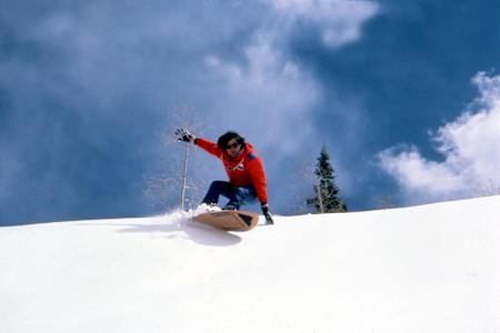 Jake Burton Carpenter on an early 'snow surfing'-style snowboard.