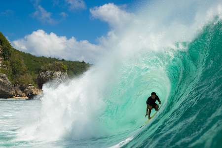 Rizal Tandjung rides the tube while surfing on Bali's Bukit Peninsula