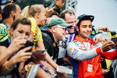 Danilo Petrucci poses for a photo with fans at the MotoGP of Austria at the Red Bull Ring on August 12, 2018.