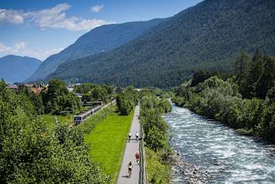 Cyclists takes to a cycling path next to the whitewater Rive Noce in Val di Sole.