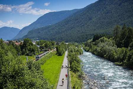 Cyclists takes to a cycling path next to the whitewater Rive Noce in Val di Sole.