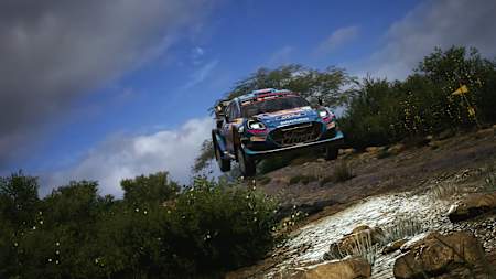 Screenshot from EA Sports WRC shows the Ford Puma1 jumping in the mud.