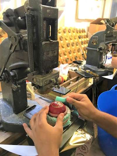Dukes cricket balls being shaped in the factory