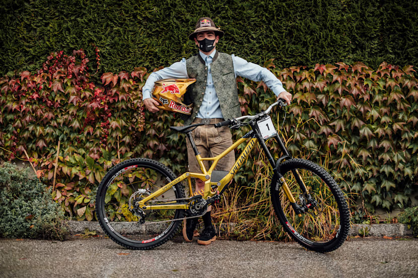 Loïc Bruni stands with his bike and helmet at Leogang MTB World Championships 2020.