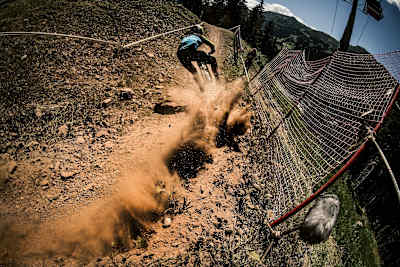 The dust flies as this rider rails this corner A competitor performs at the Lenzerheide DH World Cup in Switzerland July 6, 2017.