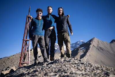 Group of guys stand for a photograph while exploring in the Andes.