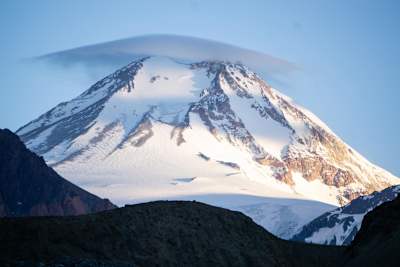 Tupungato mountain peak seen with cloud above .