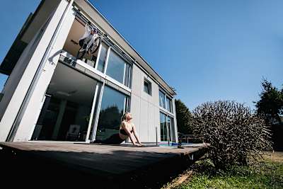 MTB trials rider Fabio Wibmer jumps over someone doing yoga on his bike during filming of his video, Home Office.