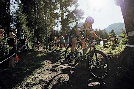 Kate Courtney rides through the woods during the XCC race at Rd 6 of the UCI MTB World Cup 2019 in Lenzerheide, Switzerland.