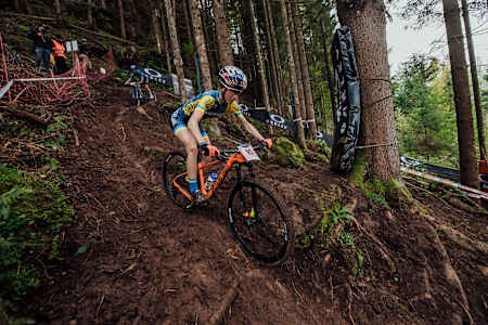 Yana Belomoina rides over roots at Leogang MTB World Champs 2020.