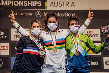 Runner-up Myriam Nicole, winner Camille Balanche and third-placed Monika Hrastnik on the Elite Women's podium at the UCI Mountain Bike Downhill World Championships in Leogang, Austria.