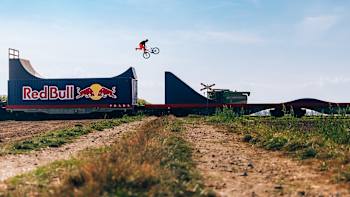 Dawid Godziek jumps a gap on a slopestyle course mounted on a moving train during Red Bull Bike Express.