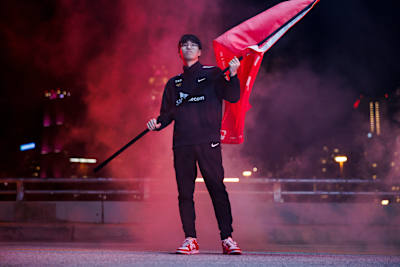 Oner lifts the flag on stage at League of Legends World Championship 2022 in Atlanta, Georgia, US
