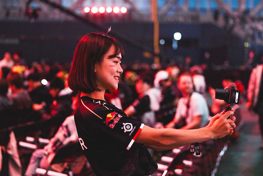 A fan of G2 Esports takes a selfie at a live League of Legends event.