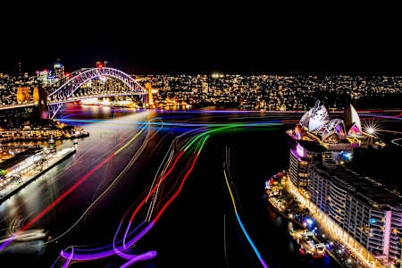 Sydney Harbour at night time with light trails.