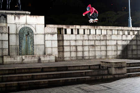 Yuto Horigome powering over and down backwards on a Tokyo night move.