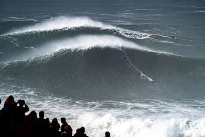 Professional big wave surfer from France, Justine Dupont, tows into a massive wave at Nazaré, Portugal