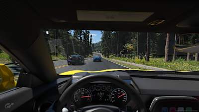 Screenshot from Gran Turismo 7 showing a race on Trial Mountain from the cockpit perspective. 