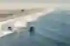 Swell lines break along the coast at Huntington Beach, California, USA.