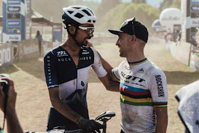 Nino Schurter at the men's podium ceremony at the 2022 Val di Sole UCI XCO MTB World Cup.