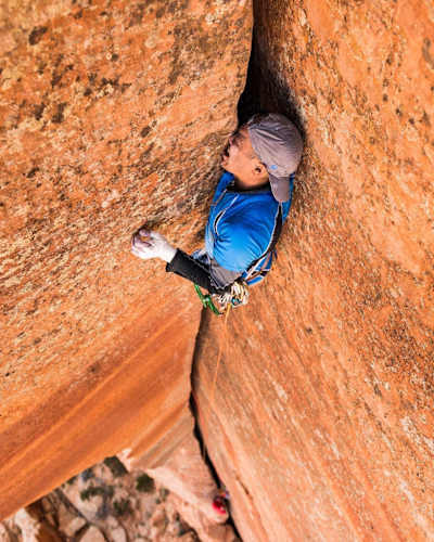 Pete Takeda wedges into a crevice at Hildale, Utah, United States shot by Greg Mionske for 2016 Red Bull Illume.