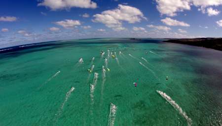 Kitesurfers riging over the sea at the International Kite Surfing Festival in Rodrigues Island, shot from a drone camera
