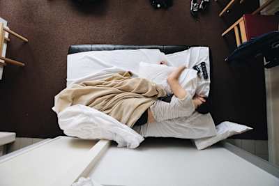 Person sleeps in bed at home.
