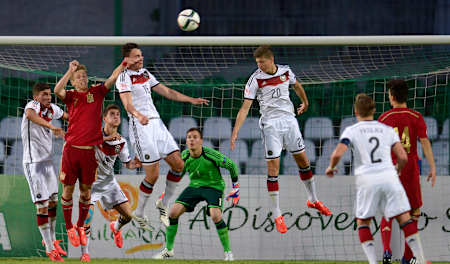 Janni-Luca Serra and Vitaly Janelt jump for the ball in front of Dani Olmo during the UEFA European Under-17 Championship match at Beroe stadium on May 15, 2015 in Stara Zagora, Bulgaria.