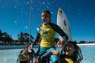 Sierra Kerr chaired up by the beach by world champ Molly Picklum, after winning Stab High in Sydney