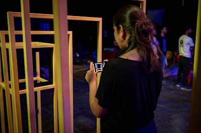 A filmmaker checks the props on a video production set.